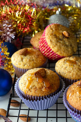 Homemade lemon muffins with poppy seeds and almond in paper case. White background. Selective focus. Christmas concept.