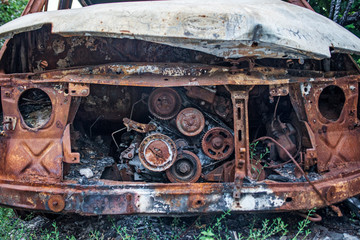 Burned car. Consequences of car accident. Damaged by arson. Machine after a fire