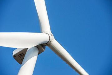 Wind turbines generating electricity with blue sky. Close up of Wind turbine producing alternative energy