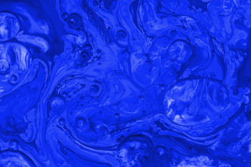Fototapeta na wymiar Color paint drops in water. Ink swirling underwater.
