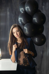 Young adorable lady posing near balloons.