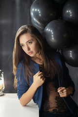Young attractive lady posing near balloons.