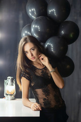 Adorable young brunette posing near a table.