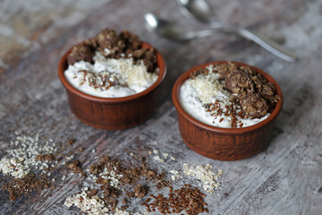 Healthy breakfast with white yogurt, chia, seeds and chocolate granola. Fitness breakfast. Vegetarian food. Keto diet. Selective focus. Macro.