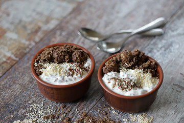 Healthy breakfast with white yogurt, chia, seeds and chocolate granola. Fitness breakfast. Vegetarian food. Keto diet. Selective focus. Macro.