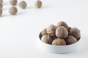 Walnut kernels, whole walnuts on white background. Healthy food for brain.