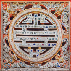Ornamental characters in round vietnamese symbol for blessings like happiness, luck and longevity in a temple in Hue, Vietnam