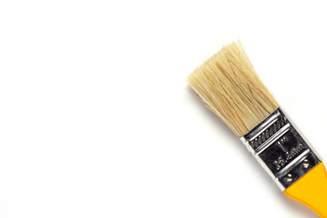 Paint brush with yellow wooden handle on white background