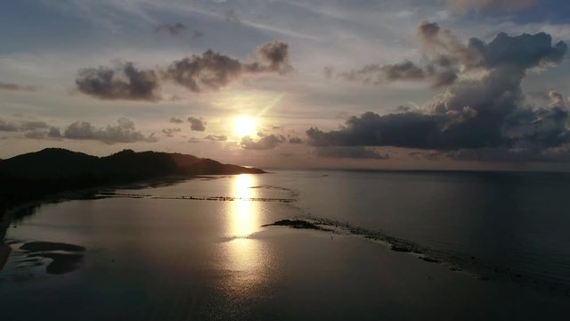 Aerial photo of sunrise over the ocean on a tropical island