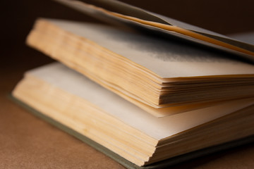 Old book on brown background in the dark close up