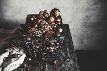 vintage christmas, new Year toys and decoration in basket on brown wooden table, copy space