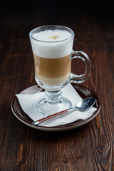 Cappuccino on a brown wooden background. Menu