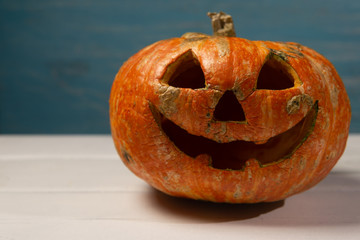 Halloween pumpkin on a wooden table on a background of white boards. Halloween background.