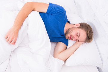 Seeing a dream. Sexy handsome man sleeping and having dream in bed alone. Early morning dream. Enjoying dream time