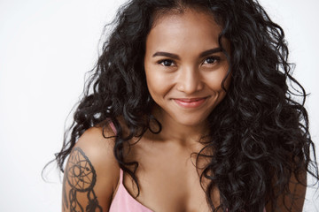 Close-up charming lovely african-american girlfriend with tattoo, pink top, smiling silly and cute, gazing camera flirty, playfully giggle as expressing tenderness, joy and positive emotions