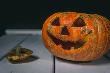 Halloween pumpkin on a wooden table on a background of white boards. Halloween background.