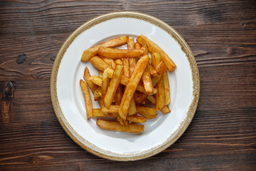 French fries on a white round plate. Restaurant menu