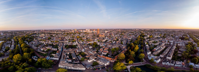 Super wide panoramic aerial view of the medieval Dutch city centre of Utrecht with cathedral towering over the city at early morning sunrise. Cityscape in The Netherlands