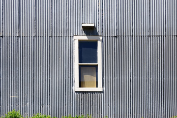 Close sectional full frame view of a white framed window in an old industrial building with...