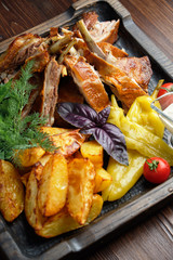 Barbecue on the bones with vegetables and potatoes . catering menu