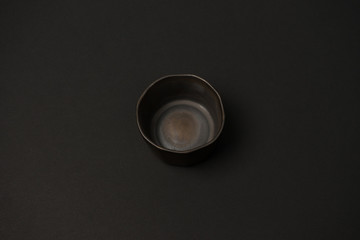 Obraz na płótnie Canvas ceramic dishes: plates and gravy boats on a black background