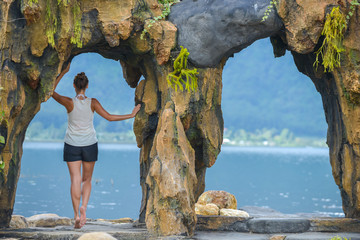 Woman looks at lake Beratan near water temple Pura Ulun Danu Beratan Bali
