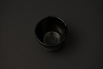 ceramic dishes: plates and gravy boats on a black background