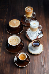 Cappuccino on a brown wooden background. Menu