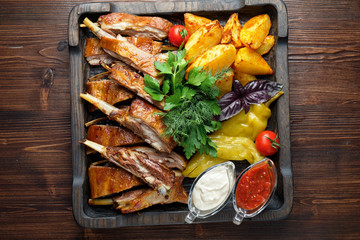 Barbecue on the bones with vegetables and potatoes . catering menu