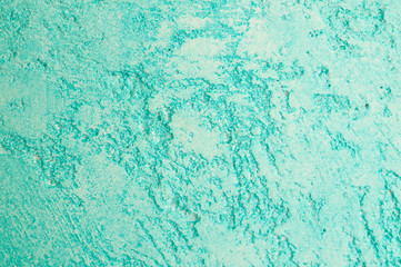 Rough texture of abstract decorative light green background of plaster wall.
