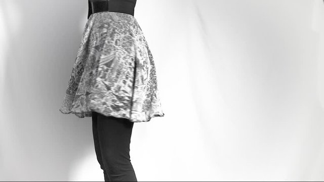 Slow motion woman spinning in a circle skirt. Close up of only the skirt and her legs.