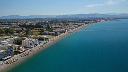 Fototapeta premium Aerial drone photo of famous seaside area and main town of Loutraki with sandy organised beach with turquoise clear sea and resorts, Greece