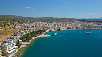 Naklejka na ściany i meble Aerial drone photo of famous seaside area and main town of Loutraki with sandy organised beach with turquoise clear sea and resorts, Greece