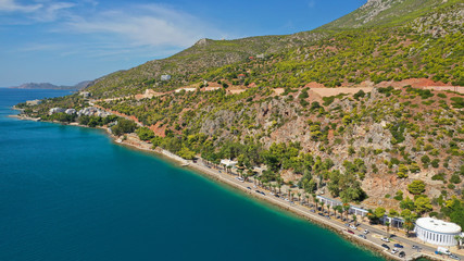 Aerial drone photo of famous seaside area and main town of Loutraki with sandy organised beach with turquoise clear sea and resorts, Greece