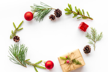 New Year frame with fir branches and present box mockup on white background top view copy space