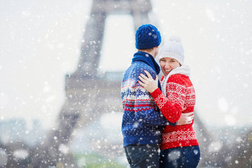 Happy couple near the Eiffel tower on a winter day