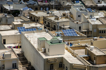 Fototapeta na wymiar Solar panels on houses in Gozo, Malta. Renewable alternative energy