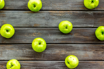 Green apples pattern on dark wooden background top view