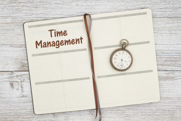 Planning your day with time management with a day planner and pocket watch