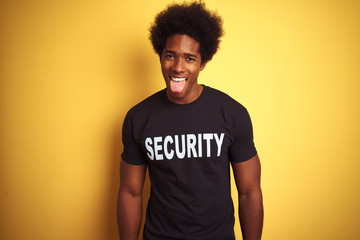 American safeguard man with afro hair wearing security uniform over isolated yellow background...