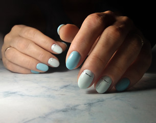 Pale blue coating of short nails with a whitish tint and silver stripe design