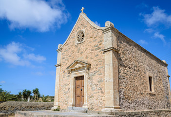Fototapeta na wymiar A small old church against a blue sky
