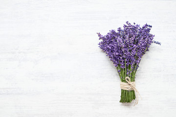 Bunch of fresh lavender on white wooden background. Top view, copy space