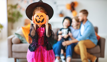 happy family mother father and children in costumes   on  Halloween.