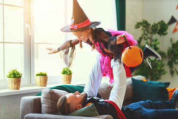 happy Halloween. family father and daughter child play in house costumes.