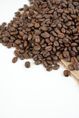 brown roasted coffee beans and coffee cup