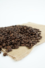 brown roasted coffee beans and coffee cup