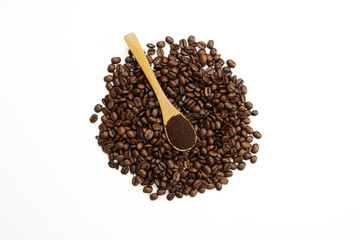 brown roasted coffee beans and coffee cup