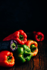 Fresh bell peppers over wooden background