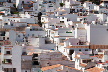 Cottages with white walls located on mountain slope on sunny day in resort town in Mijas, Malaga, Costa del Sol, Spain